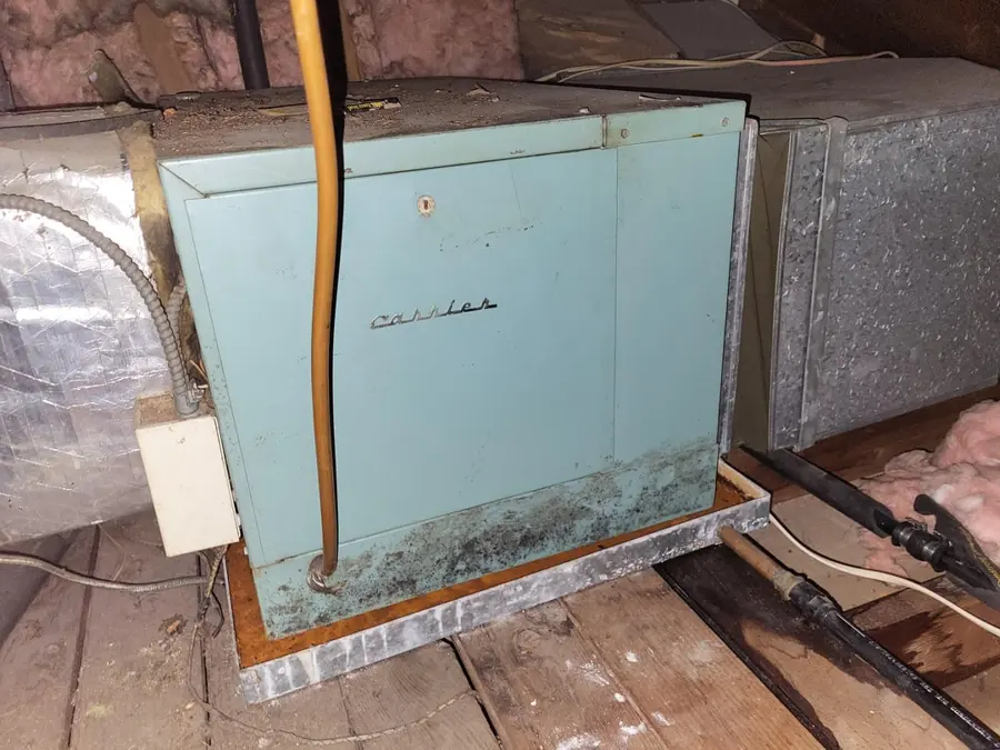 Attic air handler sitting in a rusted condensate drain pan in an Orange County home